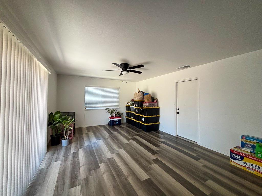 1237 De Cesari Avenue Madera, CA 93637 - Photo 28 of 33 a view of a room with wooden floor gym equipment and a large window