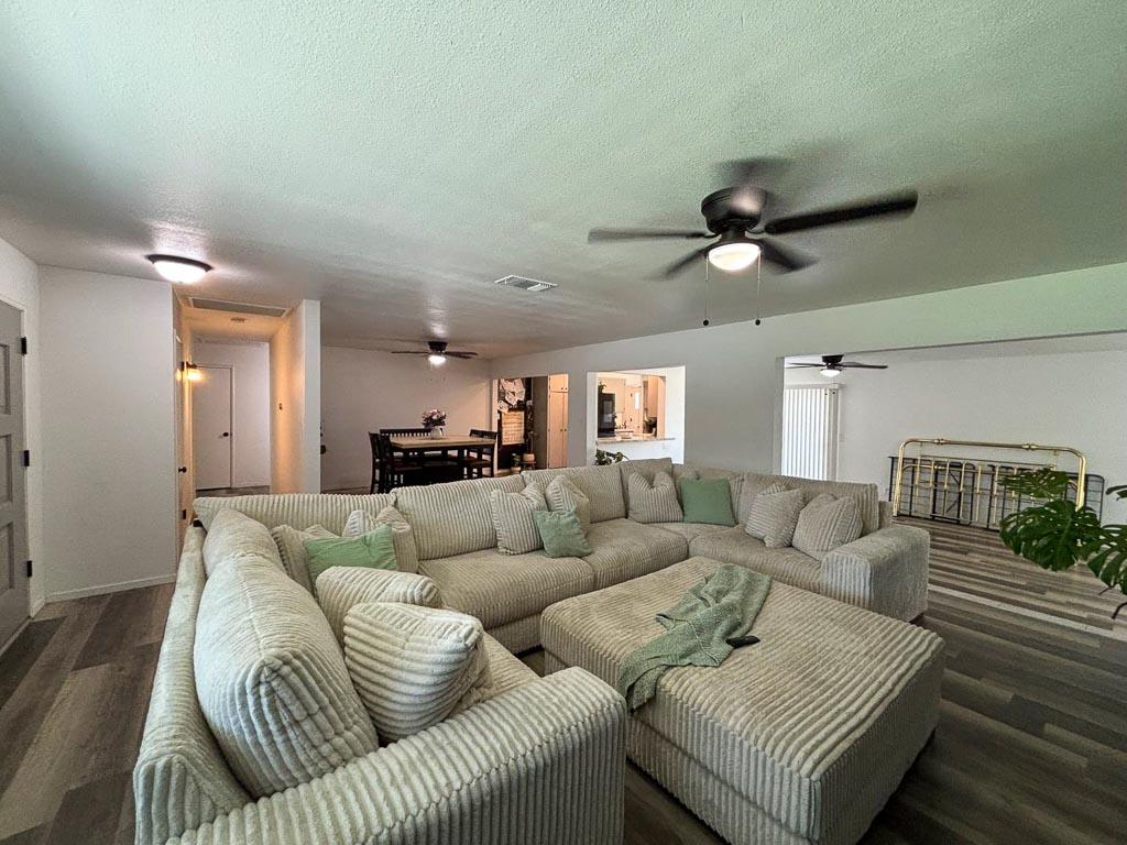 1237 De Cesari Avenue Madera, CA 93637 - Photo 7 of 33 a living room with furniture and a ceiling fan