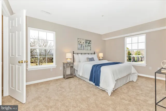 a spacious bedroom with a bed and a cabinets
