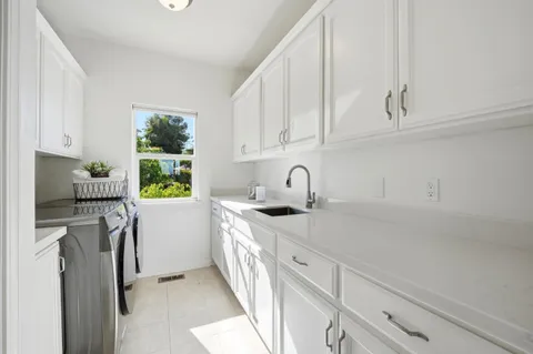 a kitchen with stainless steel appliances granite countertop a sink a stove and a refrigerator