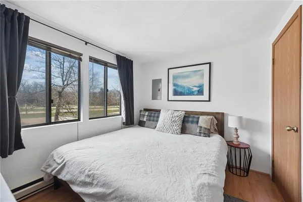 a bedroom with a large bed and a large window