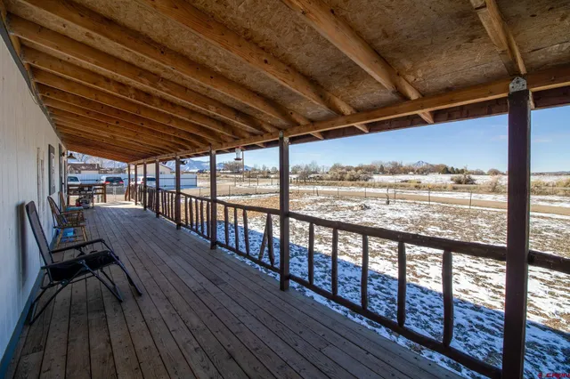 a view of a terrace with a table and chairs