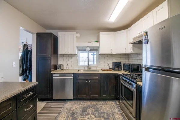 a kitchen with a refrigerator sink and stove