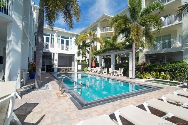 a view of a patio with swimming pool table and chairs