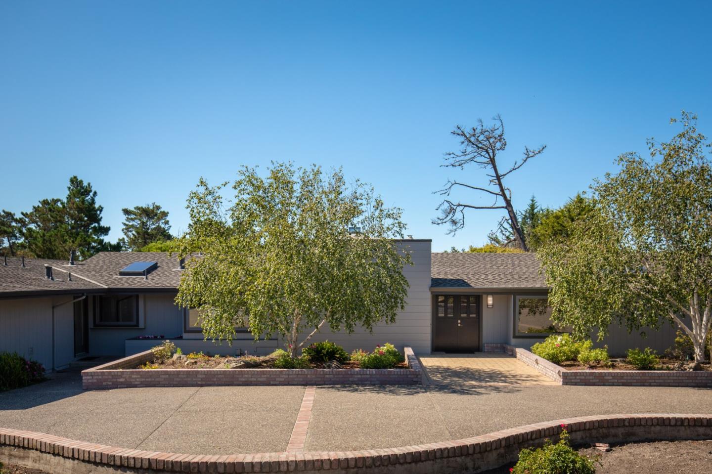 1604 Viscaino Road Pebble Beach, CA 93953 - Photo 4 of 25 a front view of a house with a yard