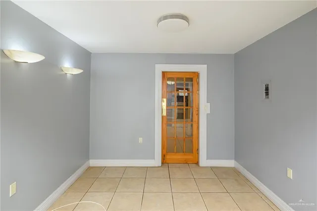 a view of an empty room with glass door