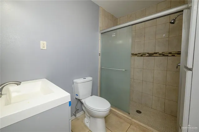 a white toilet sitting next to a bathroom sink