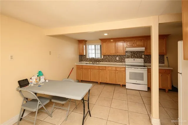 a kitchen with a sink a counter top space and stainless steel appliances