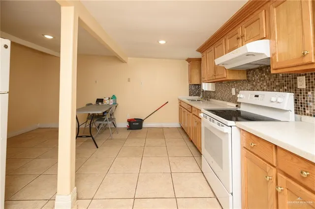 a kitchen with a sink and a stove top oven