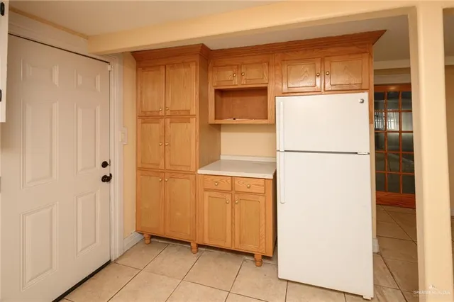 a view of a kitchen with a refrigerator and a refrigerator