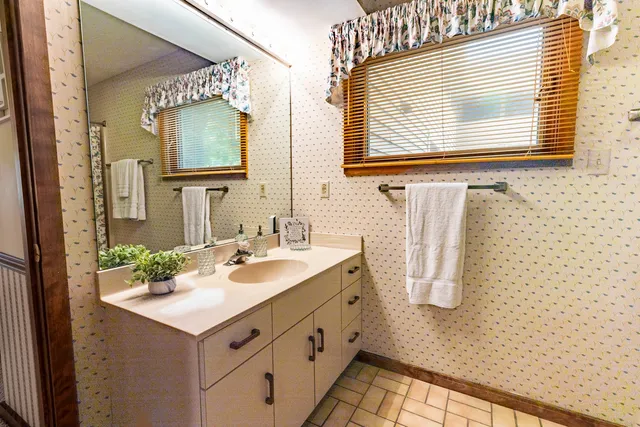 a bathroom with a sink vanity and a mirror