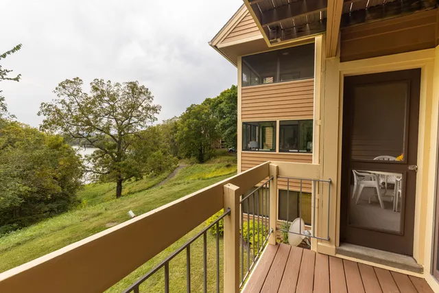 a view of a balcony with floor to ceiling windows and wooden floor
