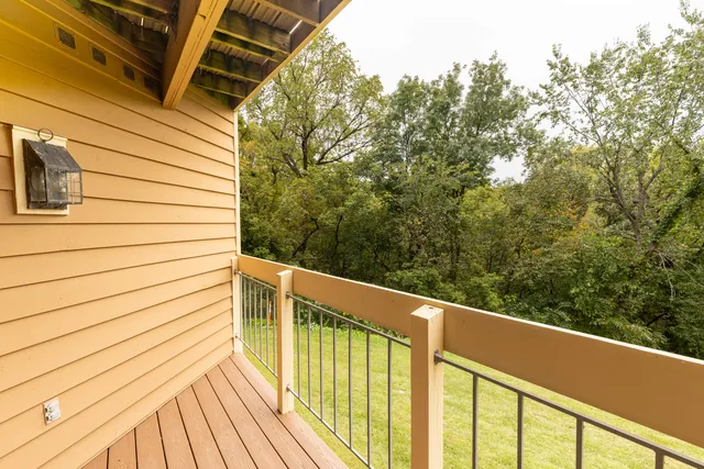 a view of a balcony with wooden floor