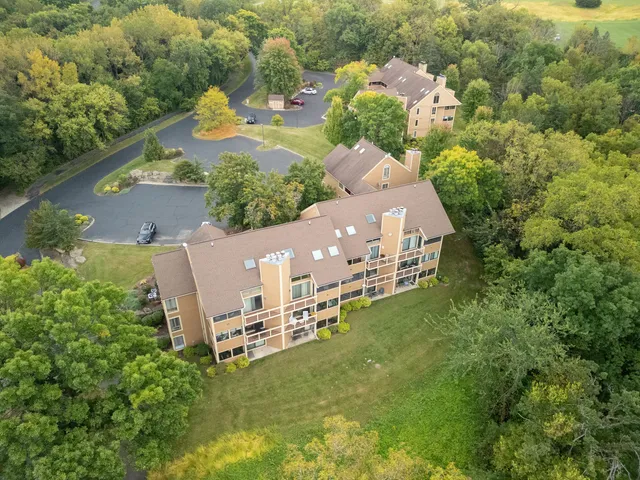 an aerial view of a house with a yard and lake view