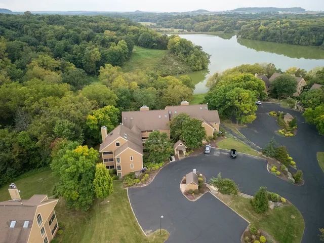 an aerial view of a house with a lake view