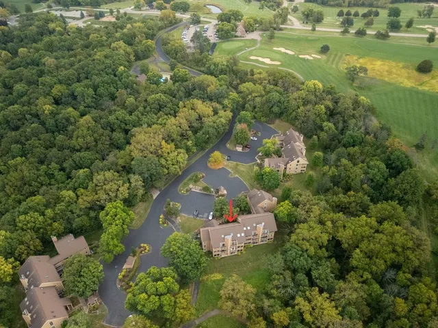 an aerial view of a house with a yard and lake view