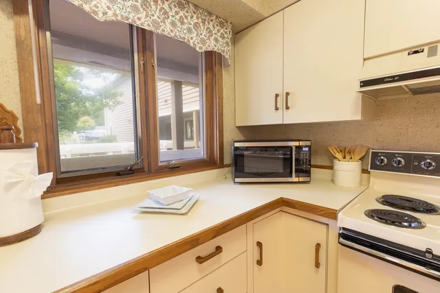 a kitchen with a stove and a white cabinets