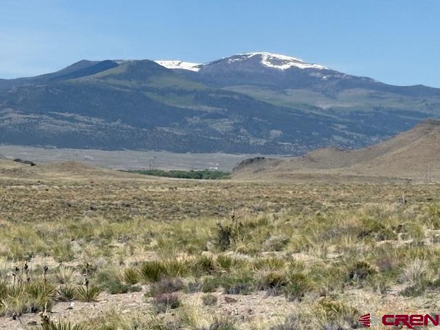 416 English Valley Road Del Norte, CO 81132 - Photo 6 of 7 a view of a dry field with mountains in the background