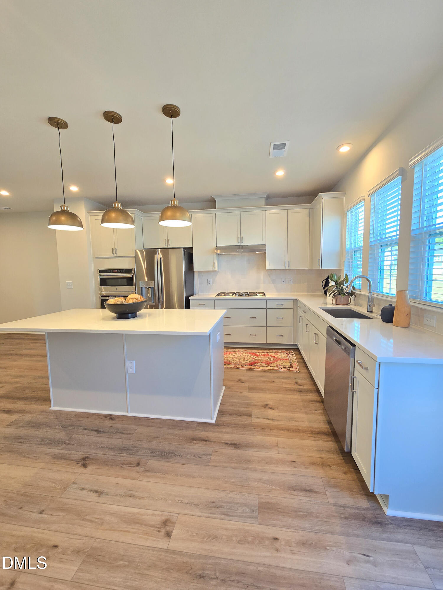 1112 Holding Village Way Wake Forest, NC 27587 - Photo 12 of 45 a kitchen with stainless steel appliances granite countertop a sink a stove top oven a counter space and cabinets