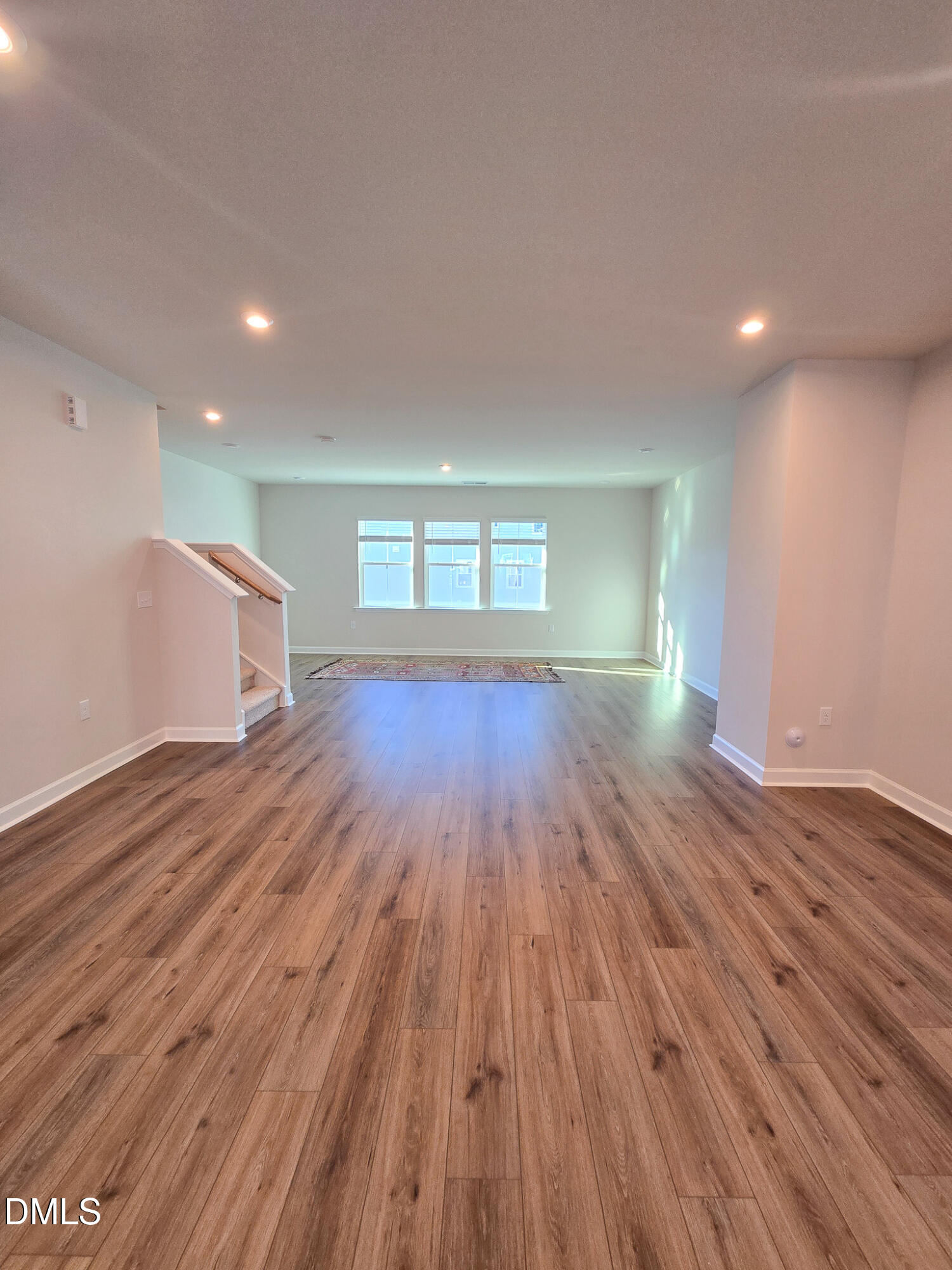 1112 Holding Village Way Wake Forest, NC 27587 - Photo 15 of 45 wooden floor in an empty room with a window