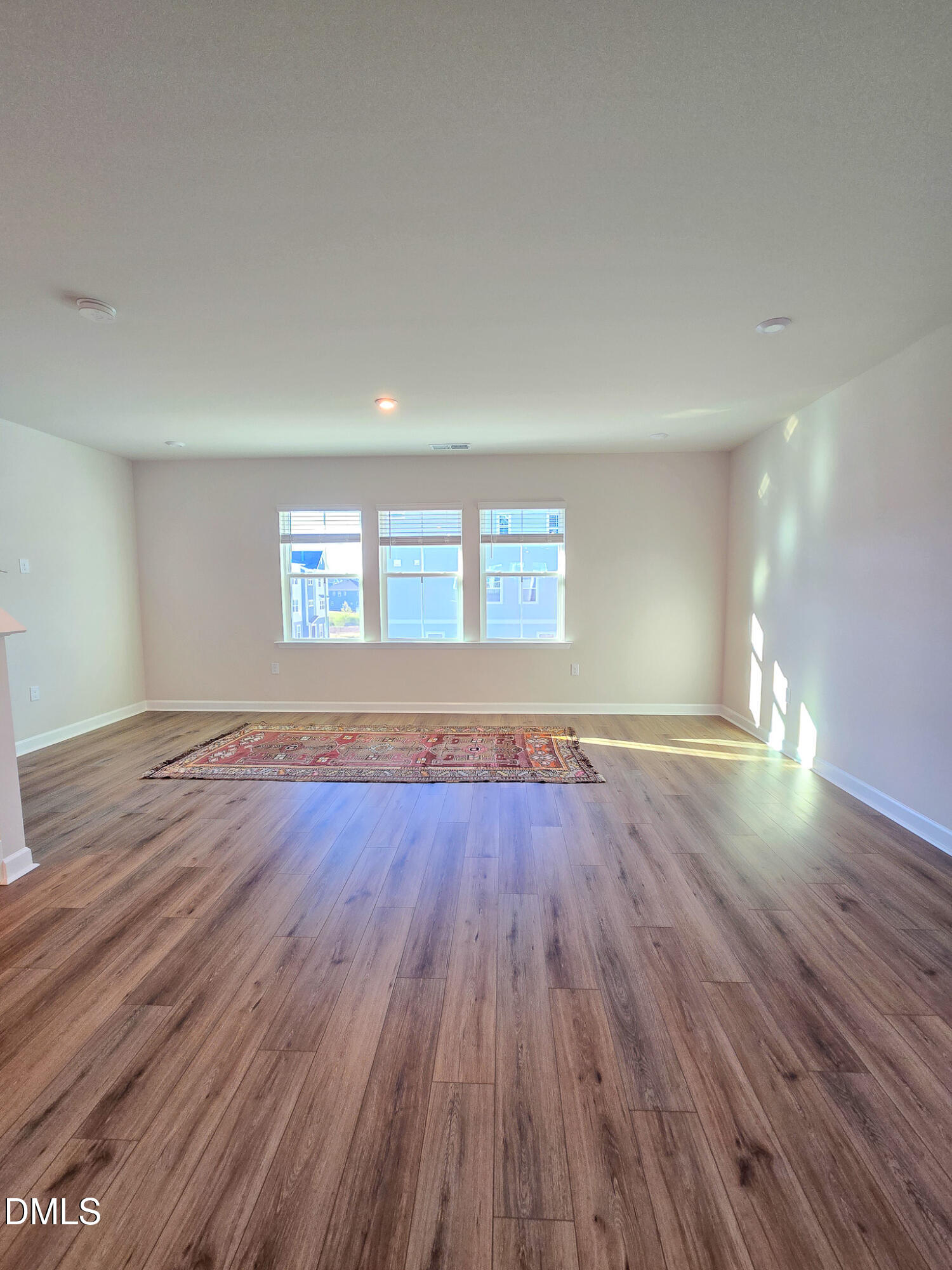 1112 Holding Village Way Wake Forest, NC 27587 - Photo 19 of 45 an empty room with wooden floor and windows