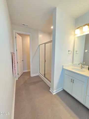 a view of a bathroom with mirror and double sink