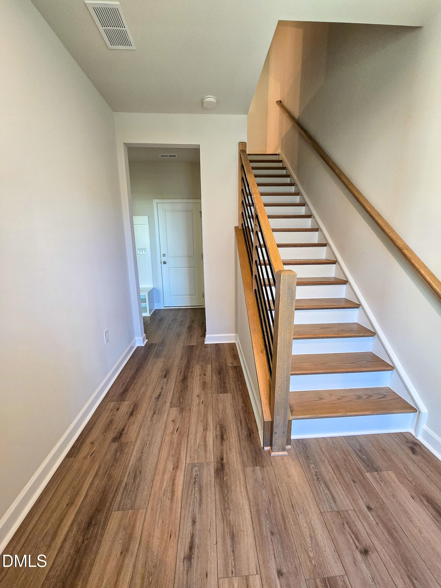 1112 Holding Village Way Wake Forest, NC 27587 - Photo 3 of 45 a view of a hallway with wooden floor and staircase