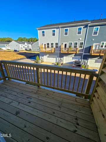 a view of roof deck with wooden floor and city view
