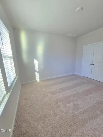 a view of an empty room and a window