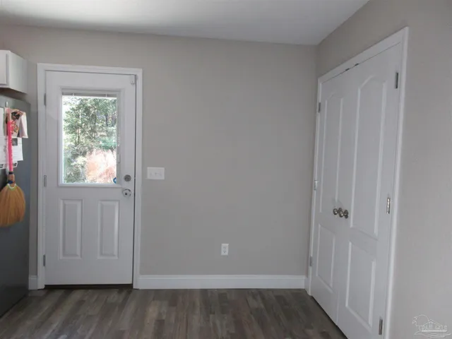 a view of a kitchen with cabinets and wooden floor
