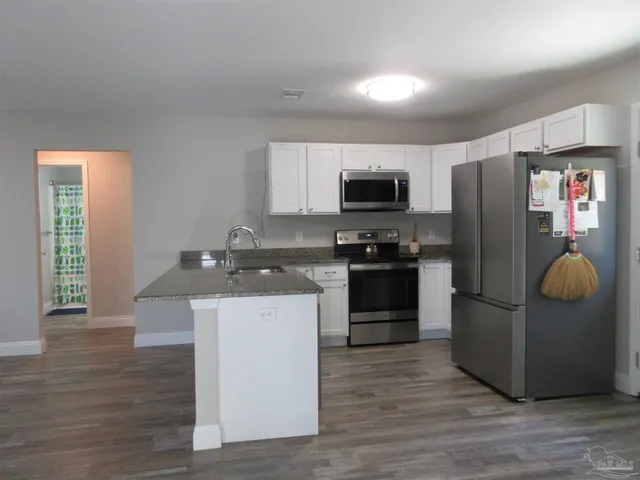 a kitchen with a refrigerator and cabinets