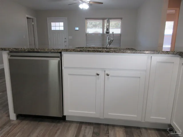 an empty room with a empty space and chandelier fan