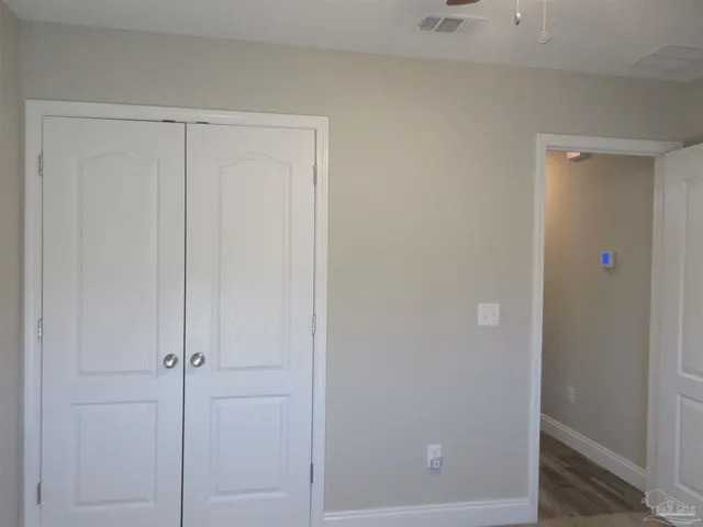 a view of a backyard with large trees