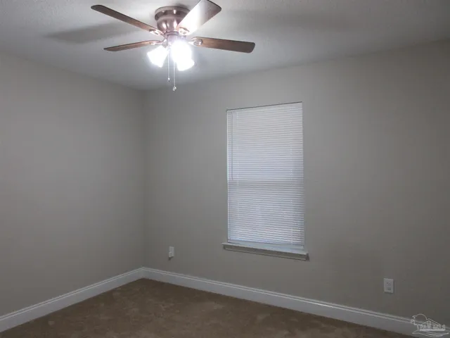 a view of a swimming pool with a yard and a fountain