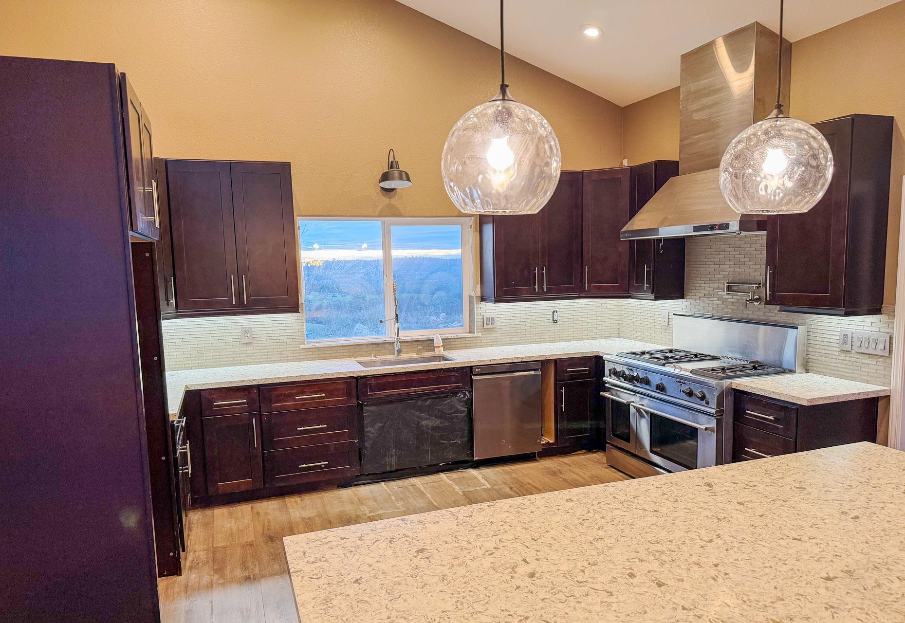 16446 Stamp Mill Loop Road East Jamestown, CA 95327 - Photo 12 of 32 a large kitchen with a large counter space and stainless steel appliances
