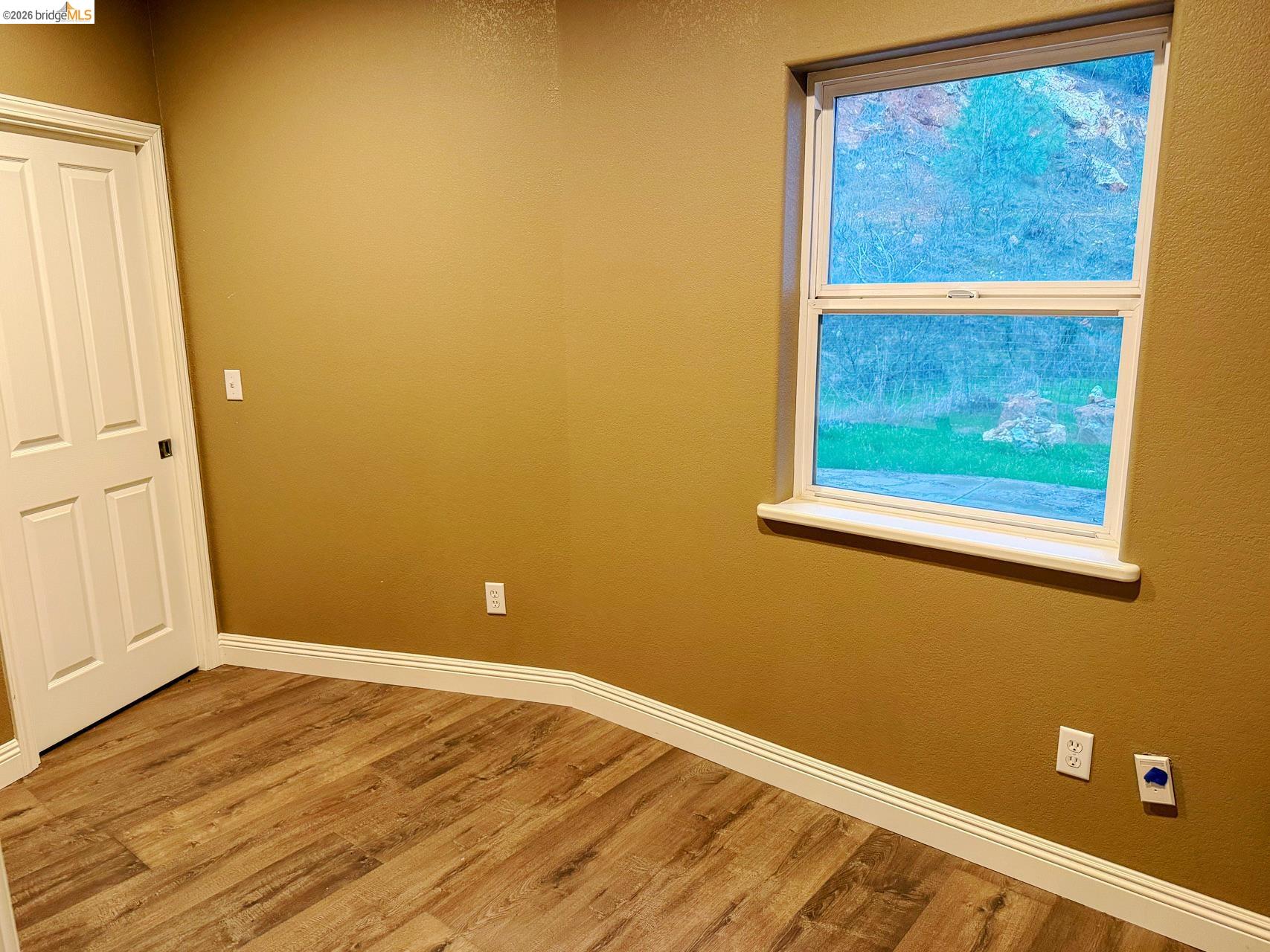 16446 Stamp Mill Loop Road East Jamestown, CA 95327 - Photo 13 of 32 a view of a small space with wooden floor and a window