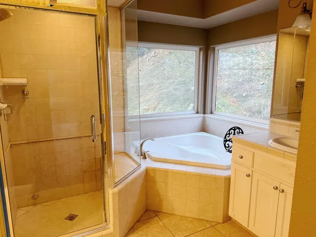 a bathroom with a granite countertop toilet a sink and a mirror