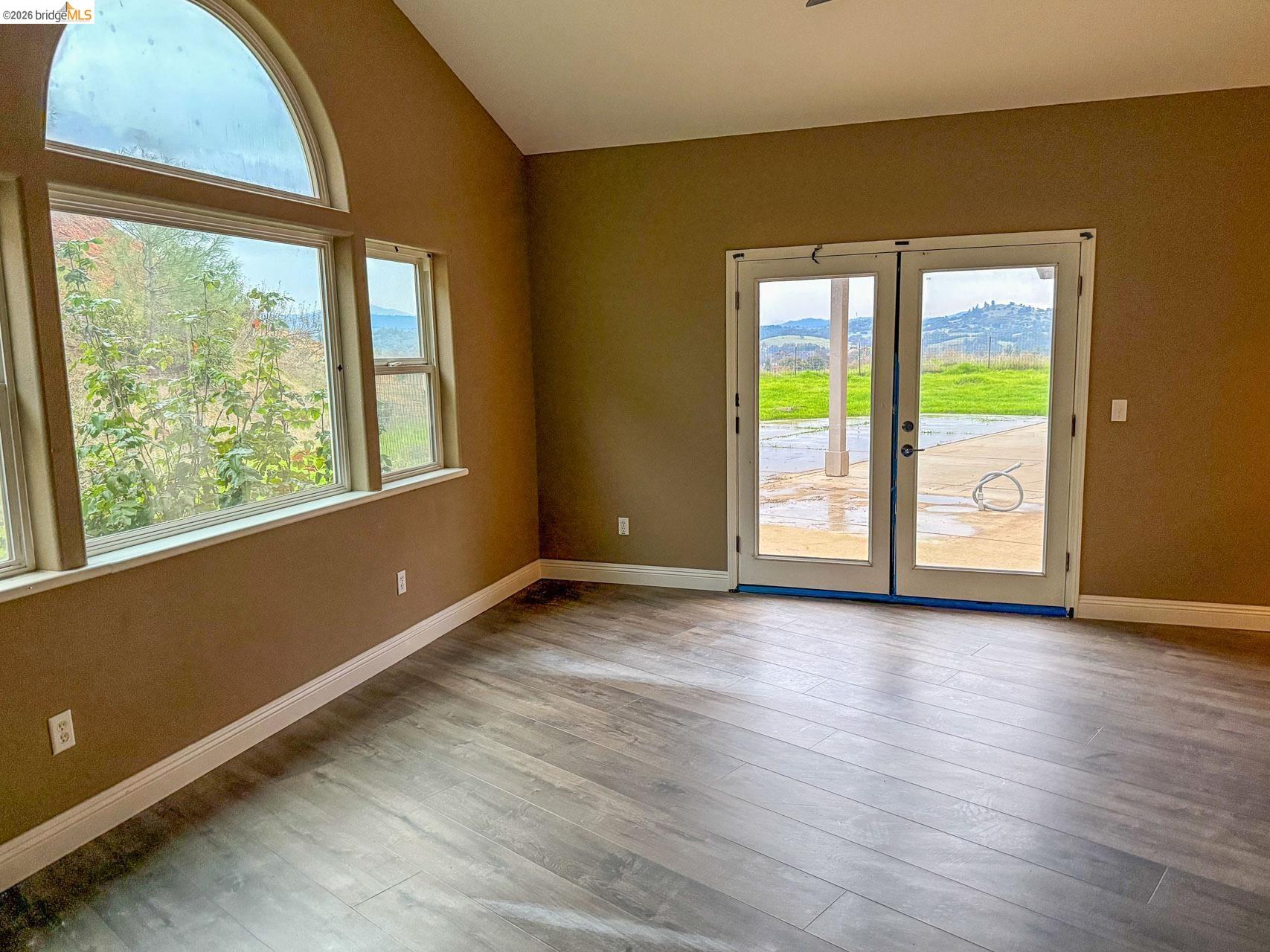 16446 Stamp Mill Loop Road East Jamestown, CA 95327 - Photo 18 of 32 a view of an empty room with wooden floor and a window