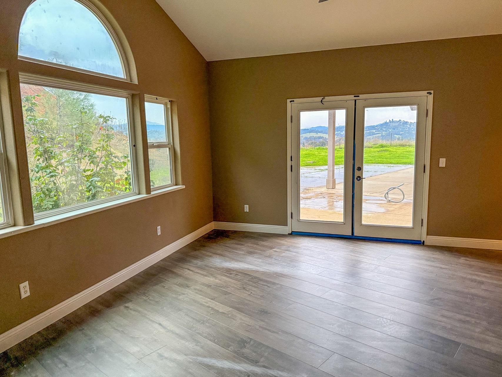 16446 Stamp Mill Loop Road East Jamestown, CA 95327 - Photo 18 of 32 a view of an empty room with wooden floor and a window
