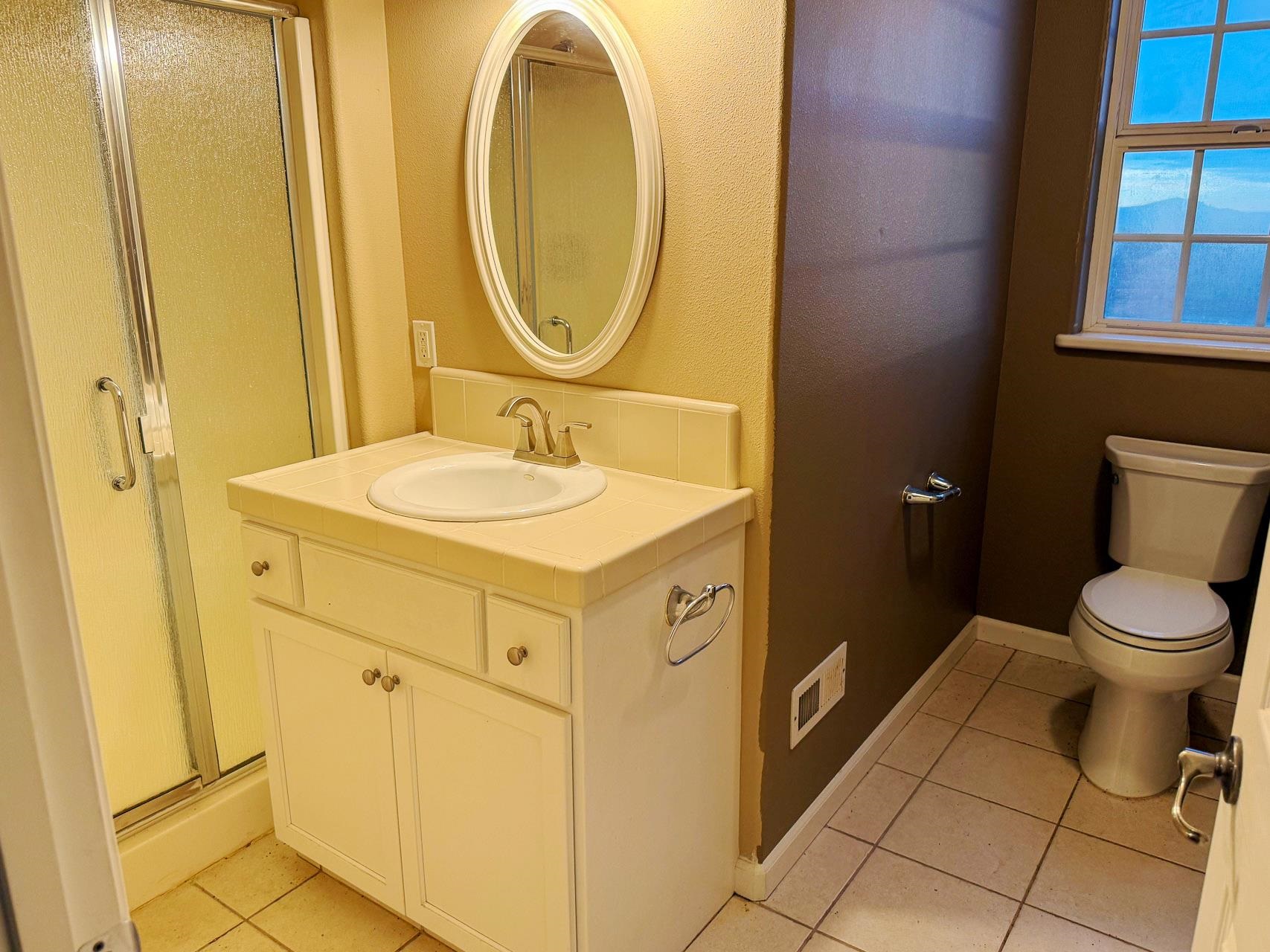 16446 Stamp Mill Loop Road East Jamestown, CA 95327 - Photo 26 of 32 a bathroom with a sink mirror vanity and toilet