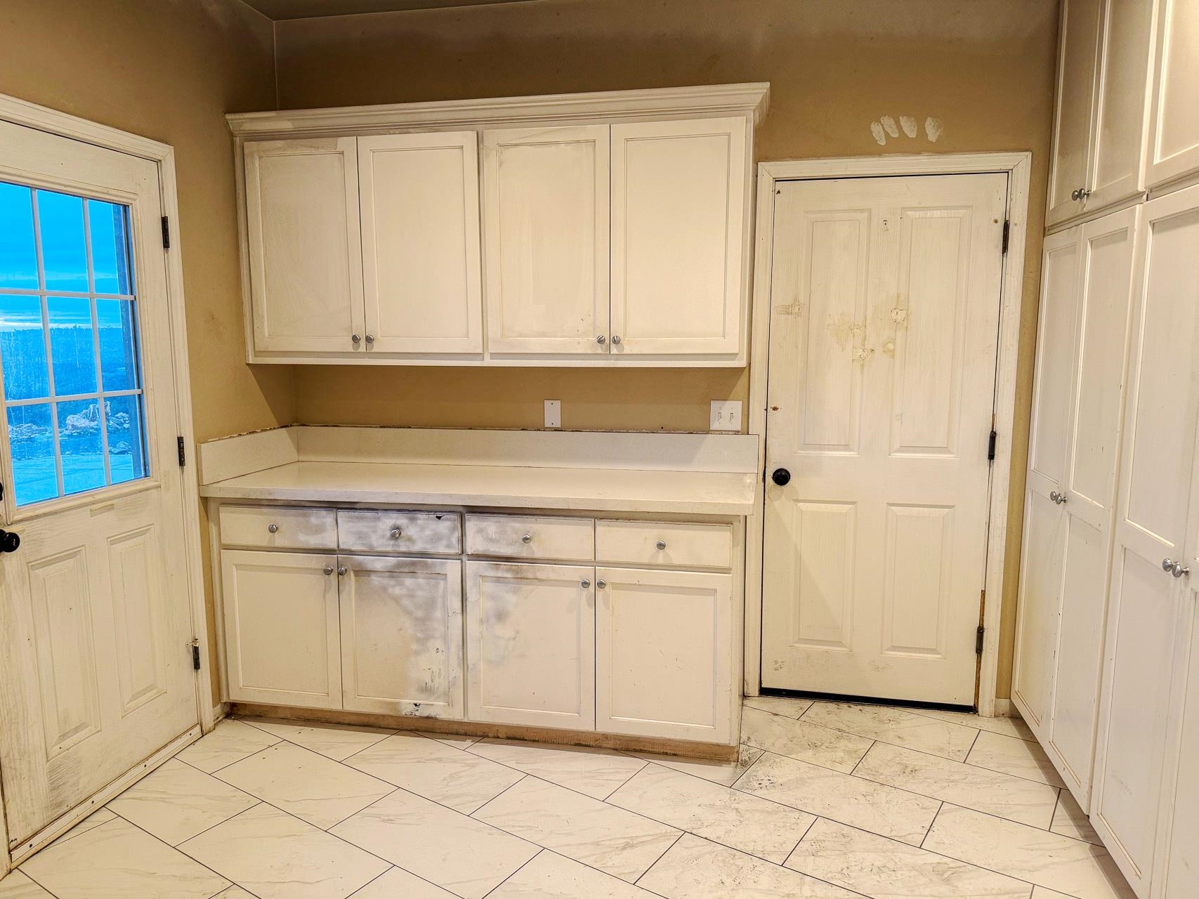 16446 Stamp Mill Loop Road East Jamestown, CA 95327 - Photo 27 of 32 a kitchen with white cabinets and a sink