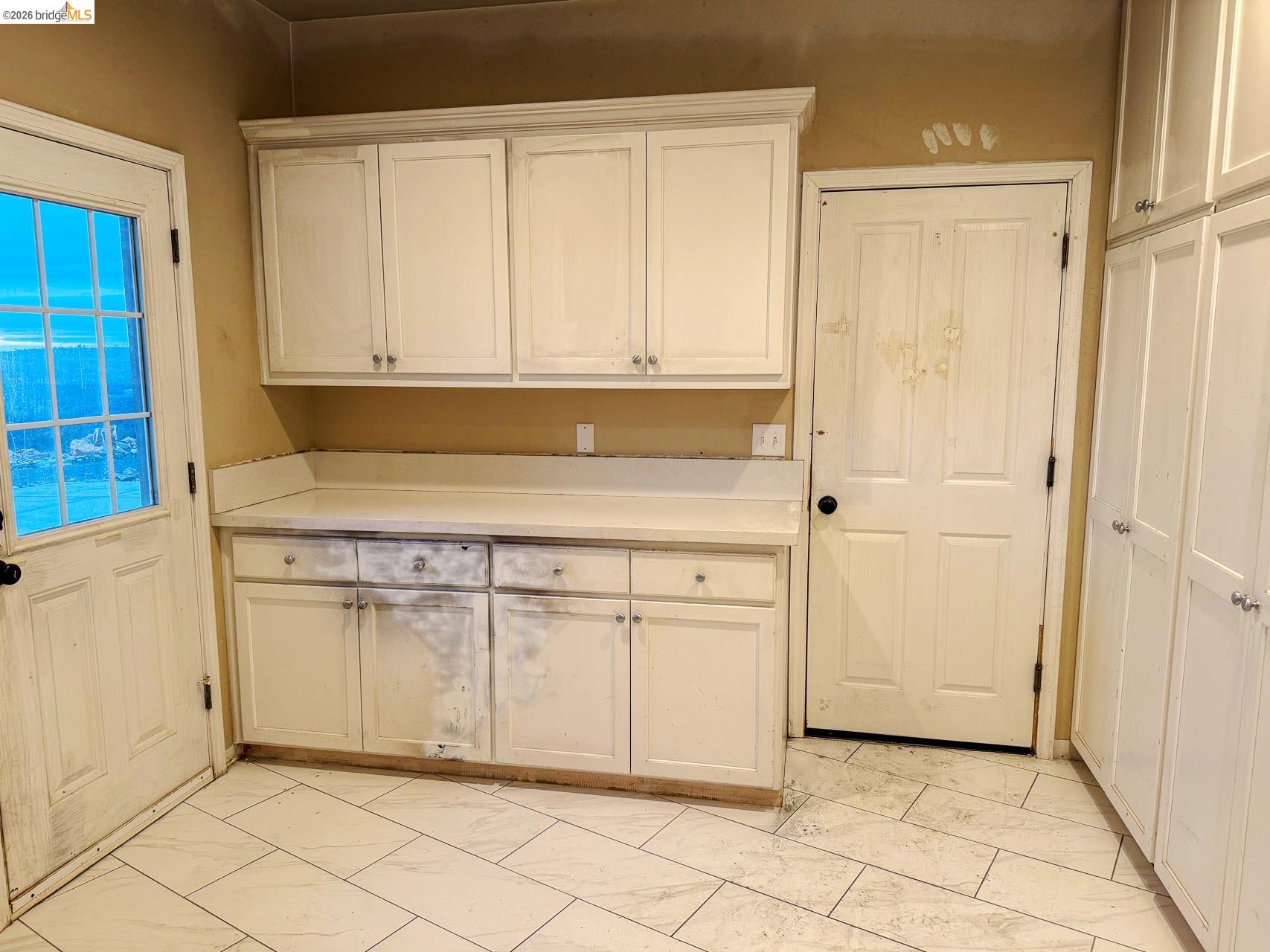 16446 Stamp Mill Loop Road East Jamestown, CA 95327 - Photo 27 of 32 a kitchen with white cabinets and a sink