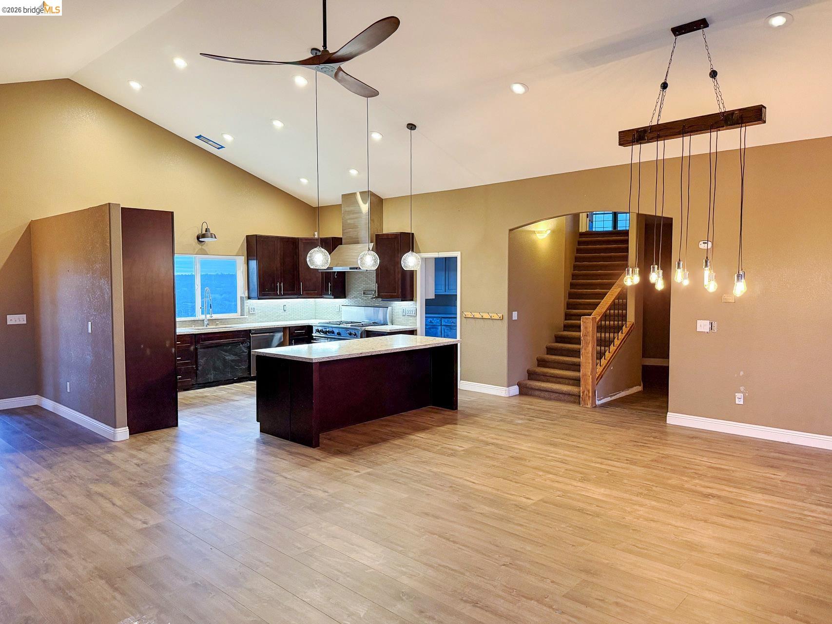 16446 Stamp Mill Loop Road East Jamestown, CA 95327 - Photo 7 of 32 a large kitchen with stainless steel appliances a large counter top a refrigerator and a stove