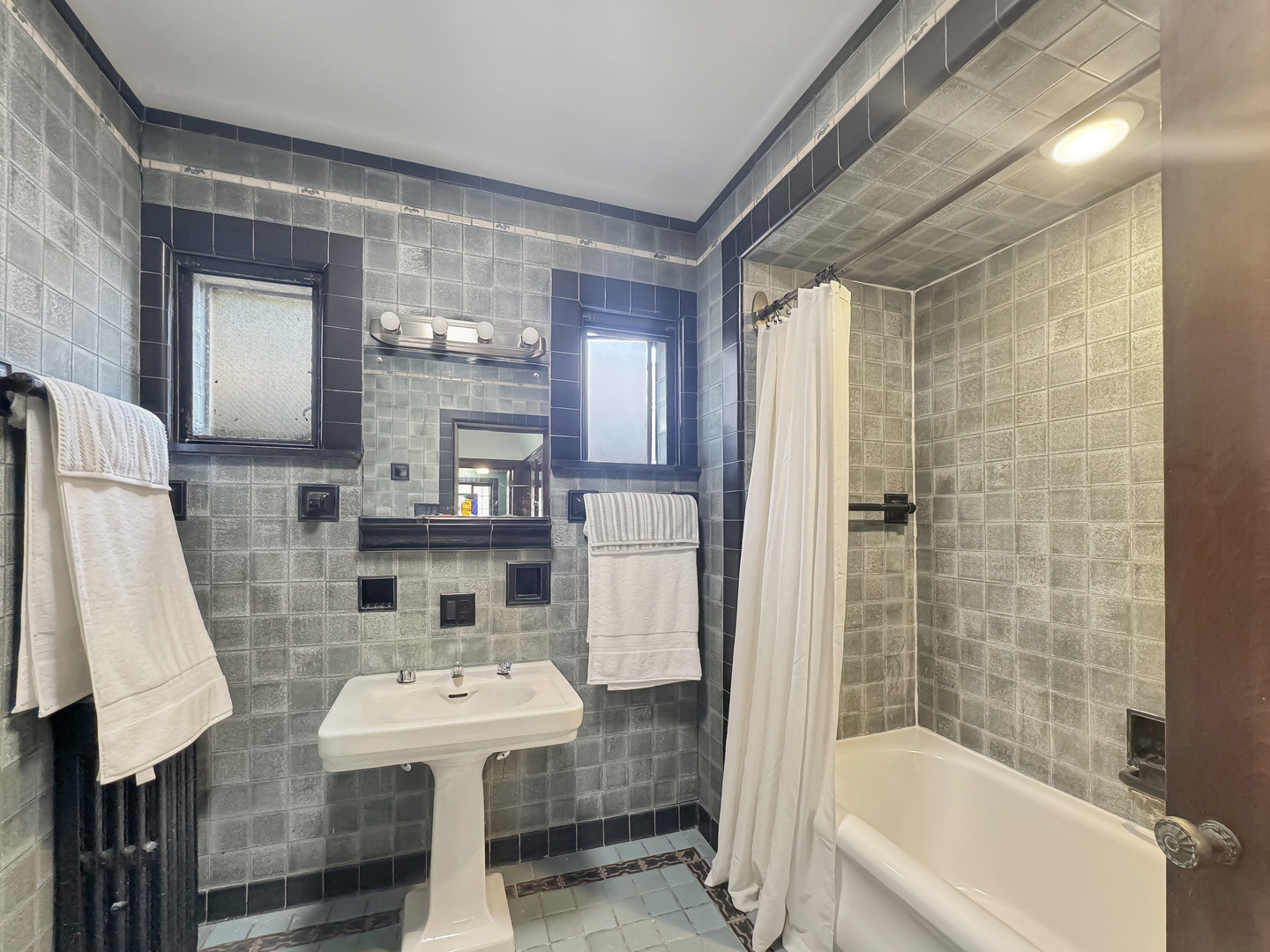 6909 South Chappel Avenue Chicago, IL 60649 - Photo 14 of 60 a bathroom with a sink a toilet and shower
