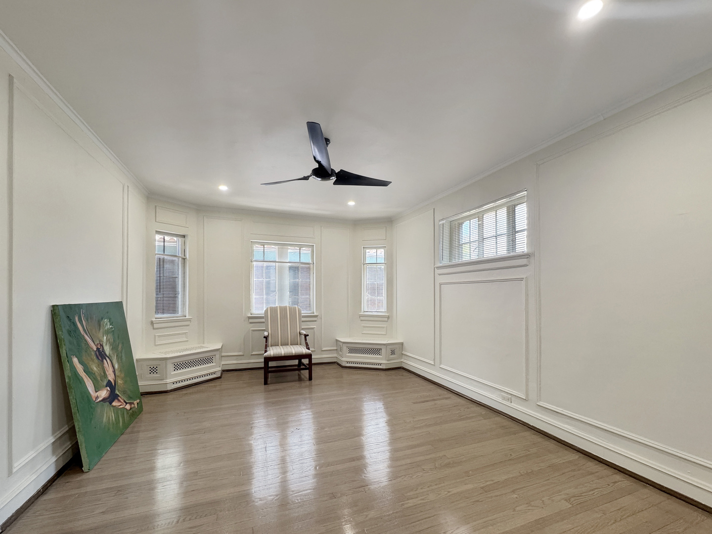 6909 South Chappel Avenue Chicago, IL 60649 - Photo 17 of 60 an empty room with wooden floor and windows