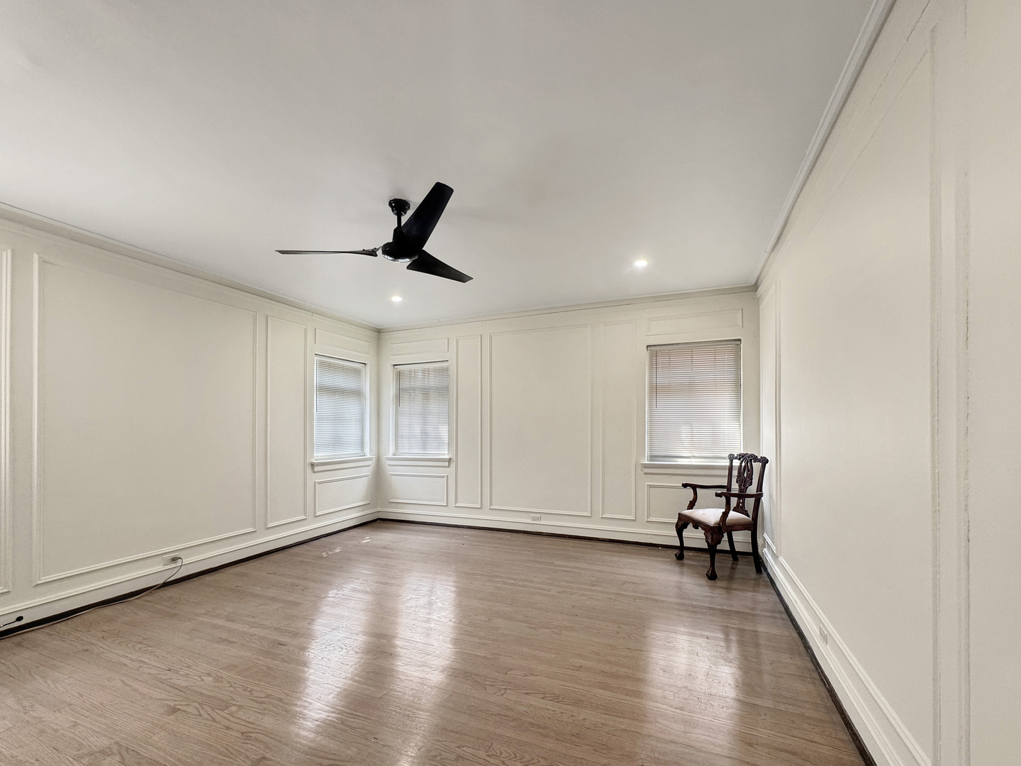 6909 South Chappel Avenue Chicago, IL 60649 - Photo 18 of 60 a view of empty room with wooden floor and fan