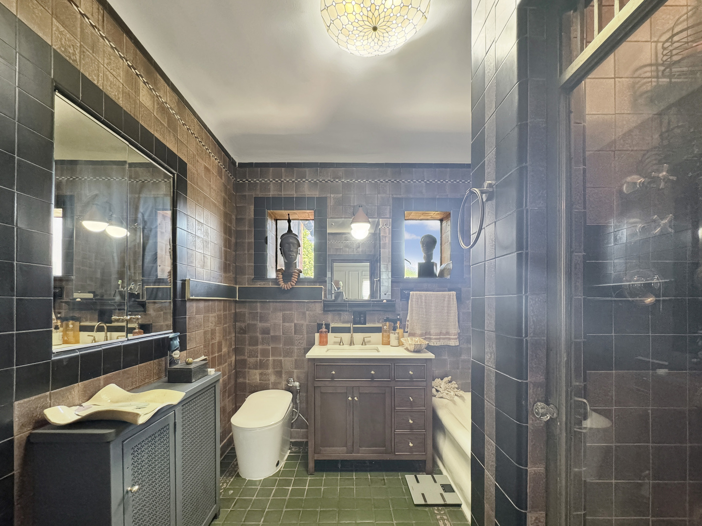 6909 South Chappel Avenue Chicago, IL 60649 - Photo 34 of 60 a bathroom with a sink a toilet and shower