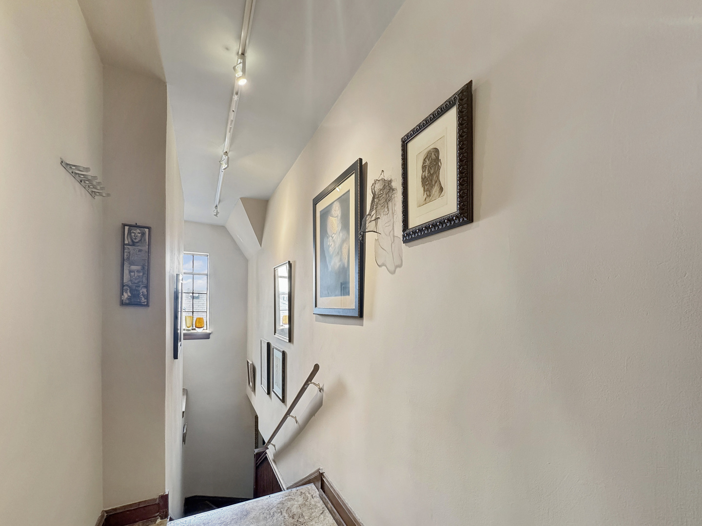 6909 South Chappel Avenue Chicago, IL 60649 - Photo 46 of 60 a view of a hallway with paintings on the wall