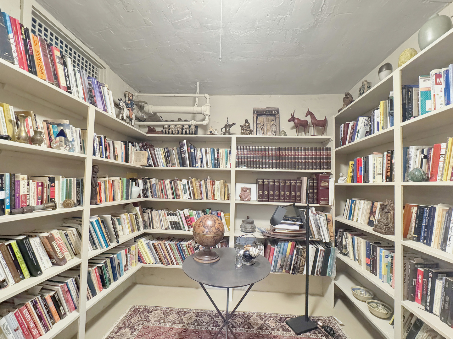 6909 South Chappel Avenue Chicago, IL 60649 - Photo 50 of 60 a view of a workspace with bookshelf and a book shelf