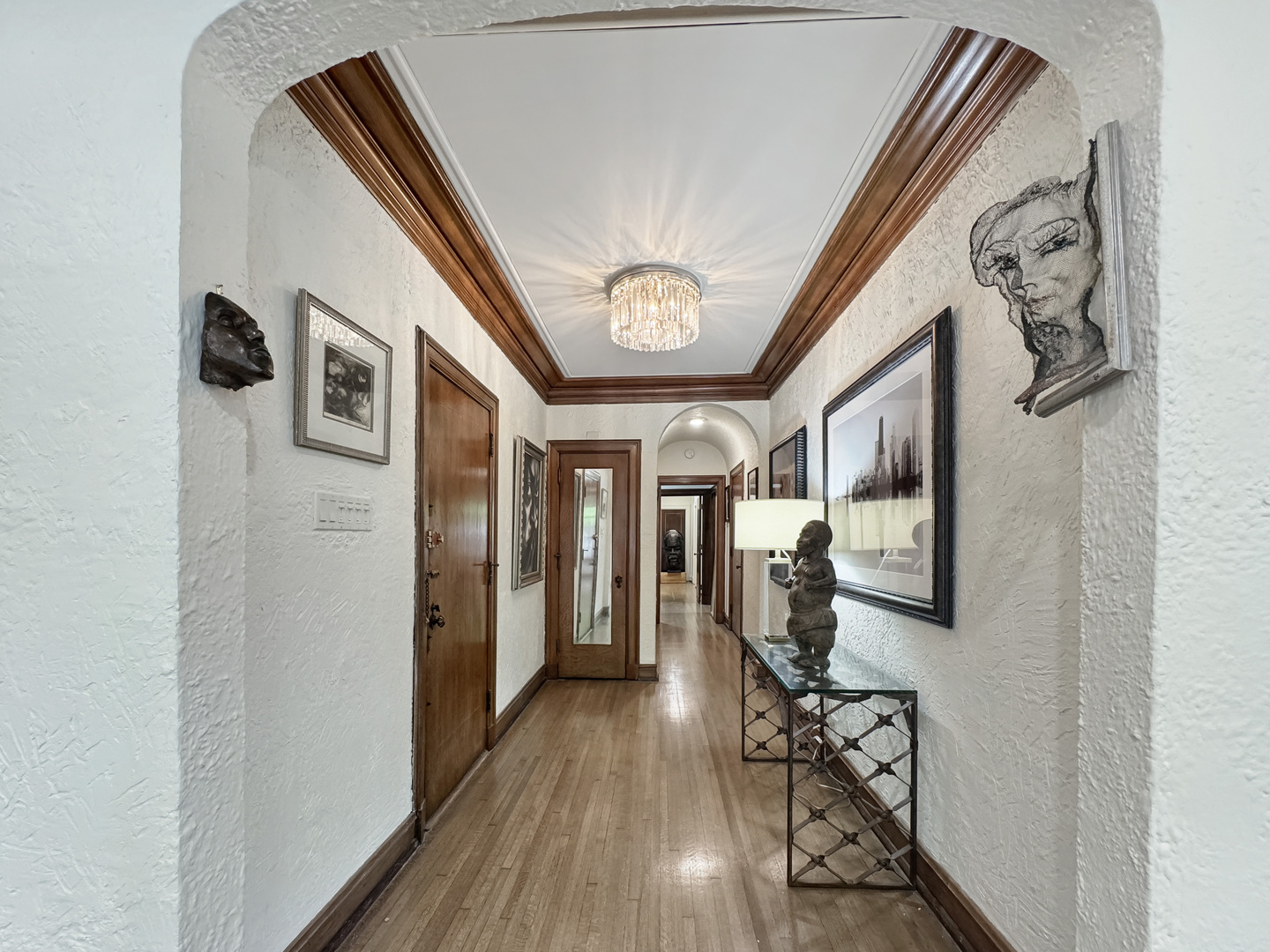 6909 South Chappel Avenue Chicago, IL 60649 - Photo 8 of 60 a view of a hallway with wooden floor and windows